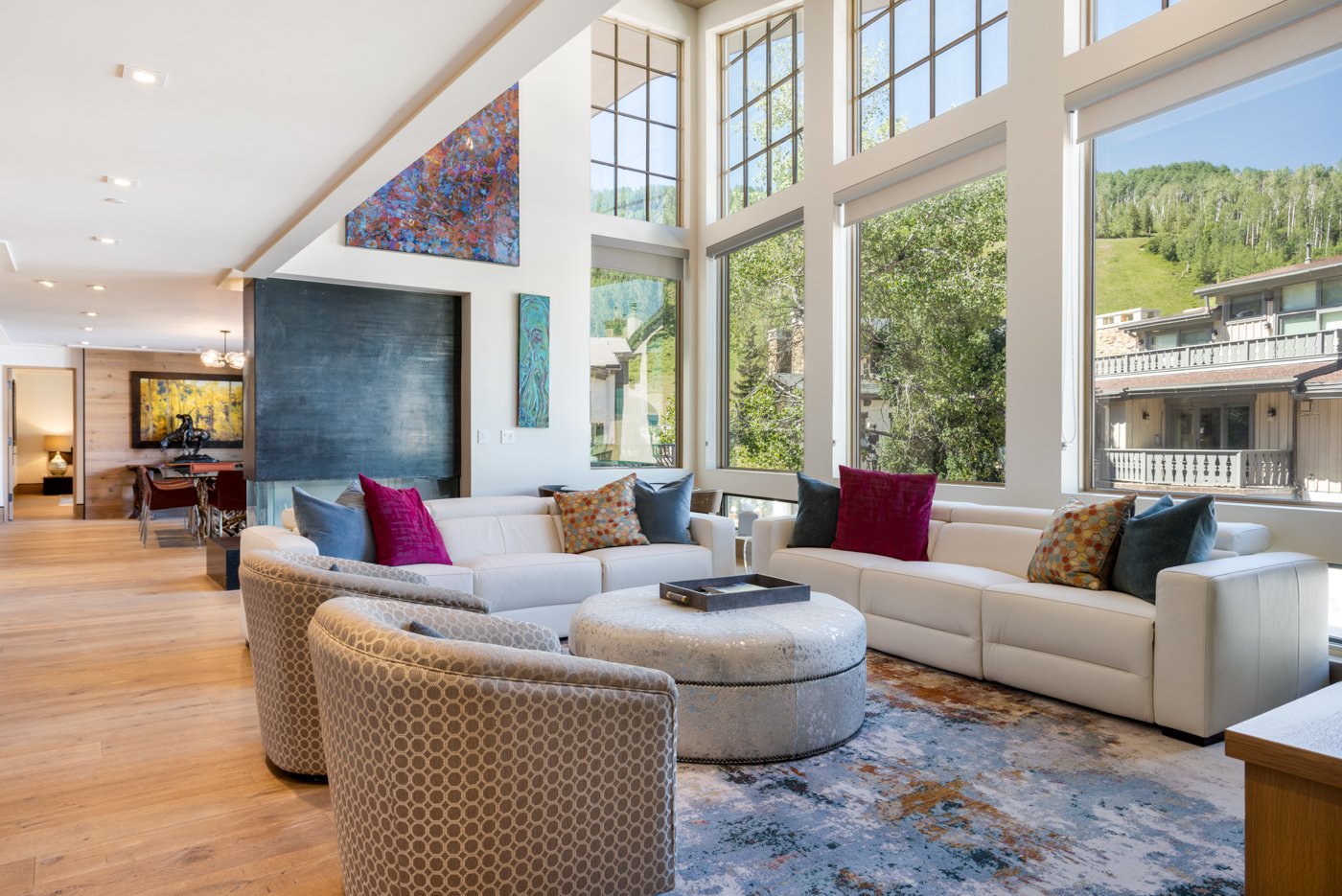 Bright living room with floor-to-ceiling mountain views in a Bridge Street condo, Vail Village